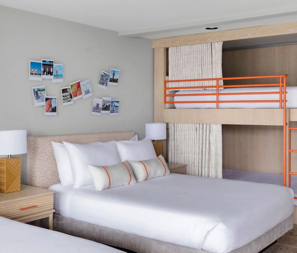 a room with two beds and a bunk bed