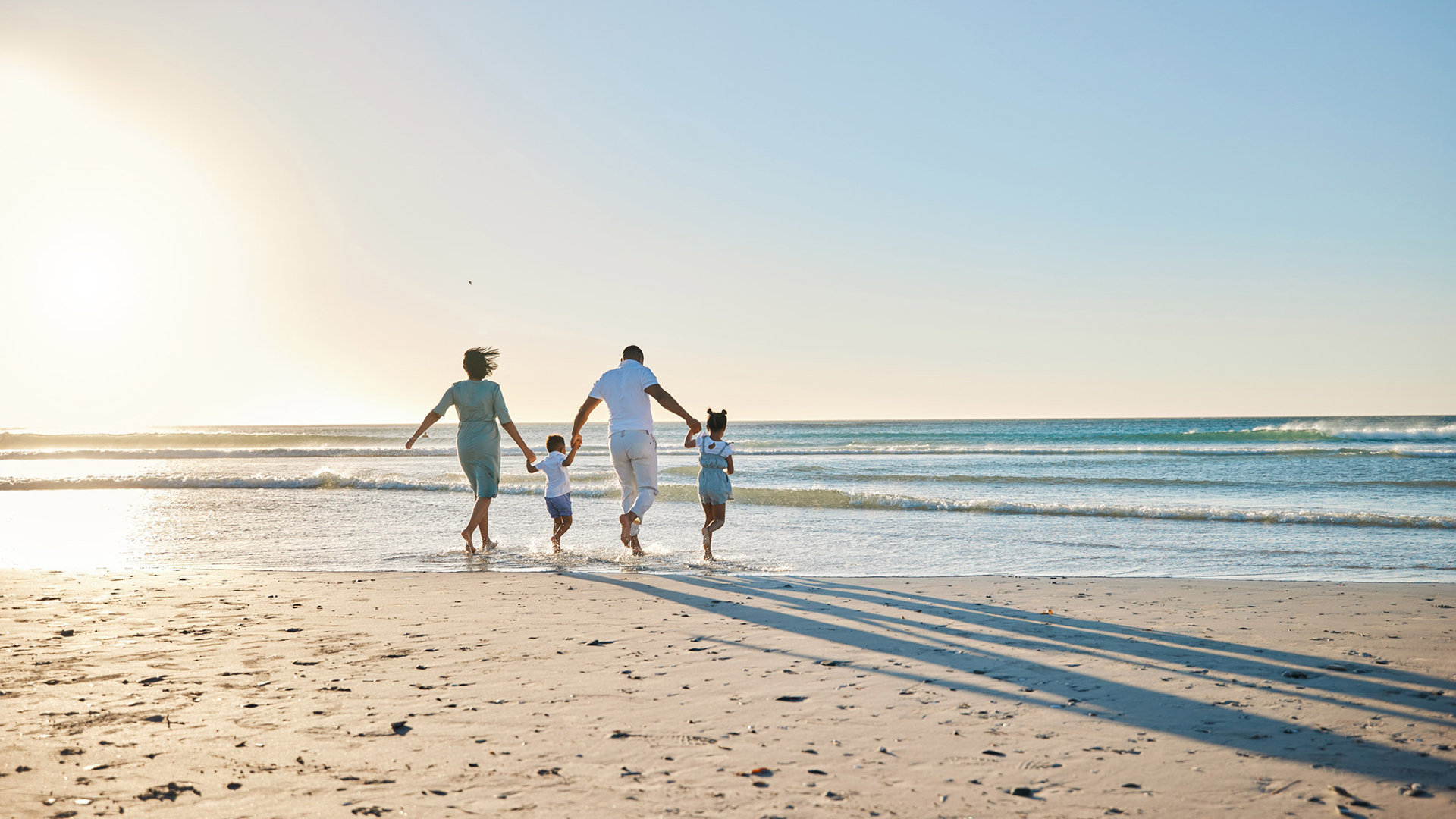 a family running on a beach