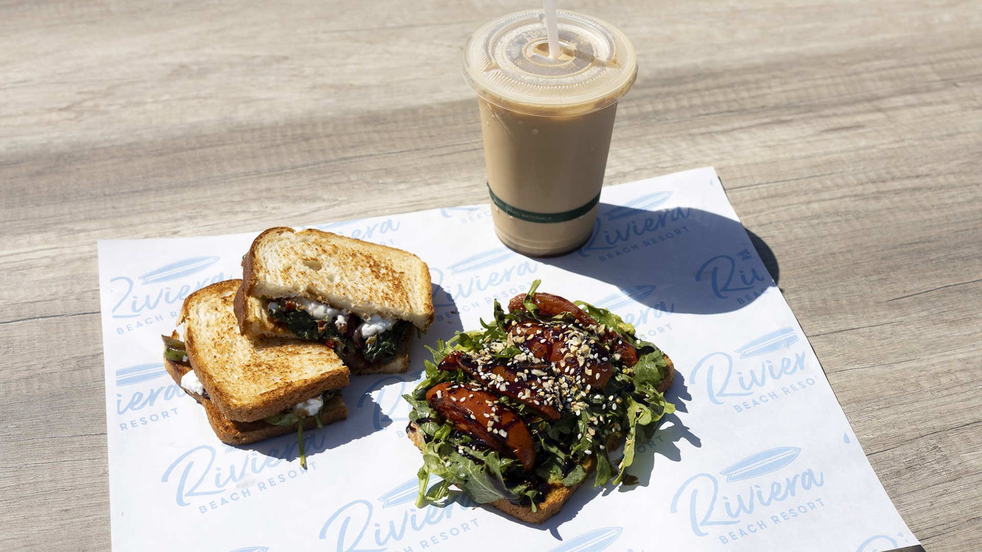 a sandwich and a drink on a napkin