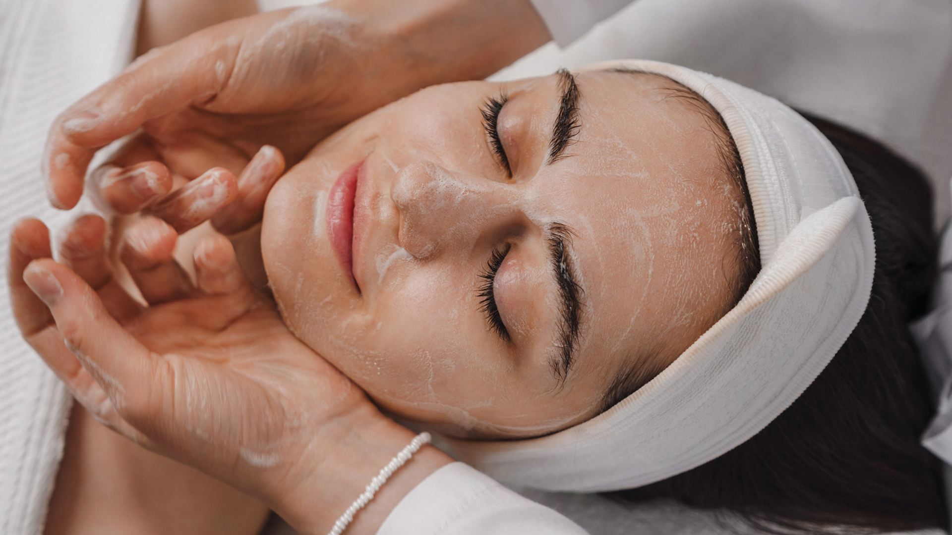 a woman with a white towel on her head