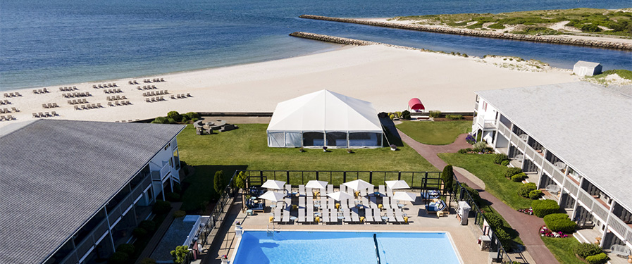 a white tent next to a pool