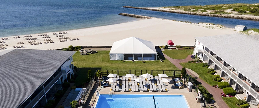 a white tent next to a pool