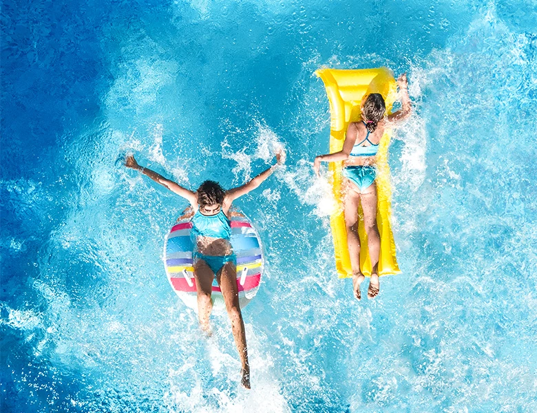 two girls swimming in a pool