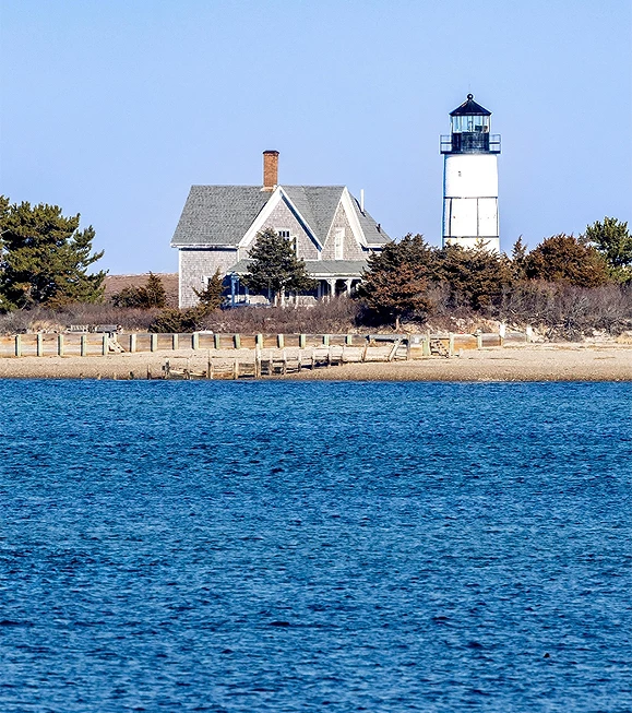 a lighthouse next to a body of water