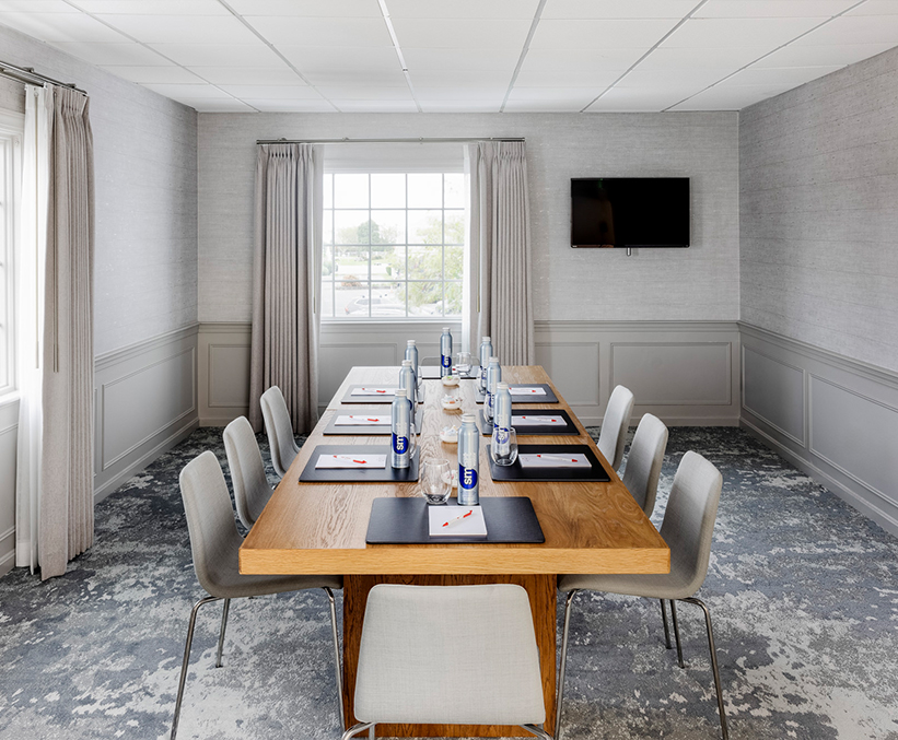 a table with drinks and chairs in a room