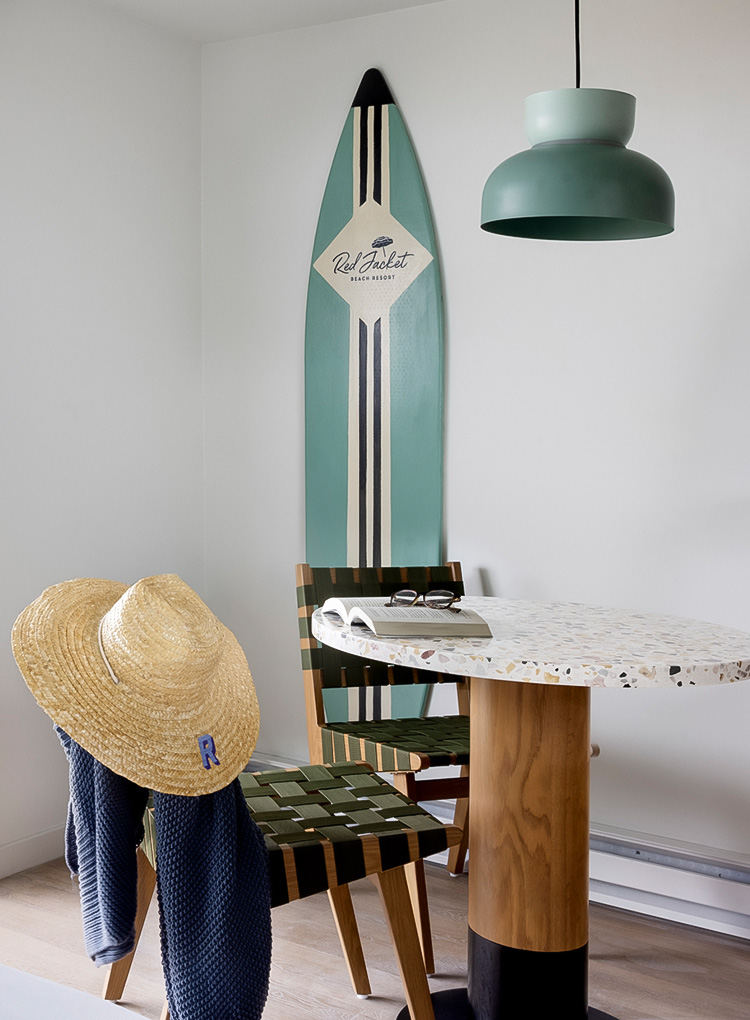 a table with a surfboard and a hat