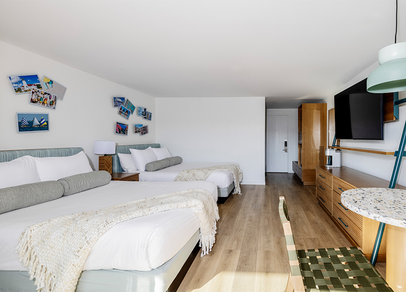 a room with two beds and a television