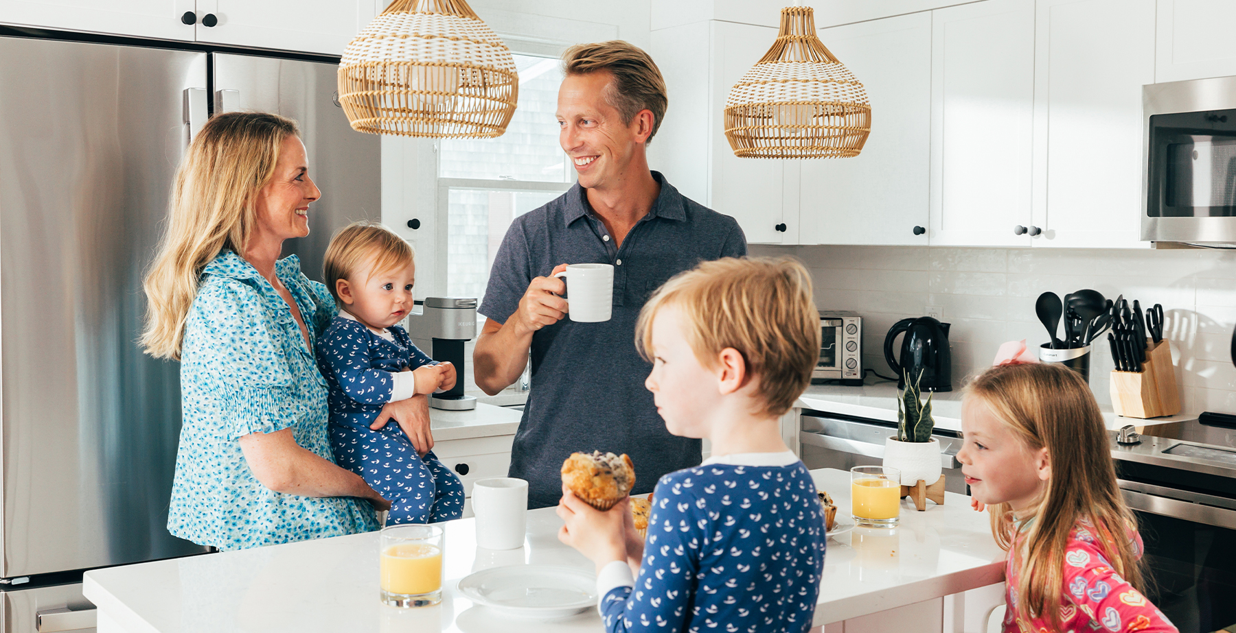 a man and woman with children in kitchen