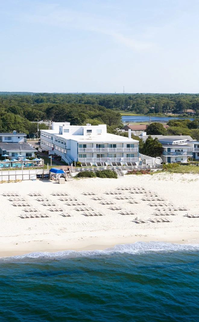 a beach with chairs and a building