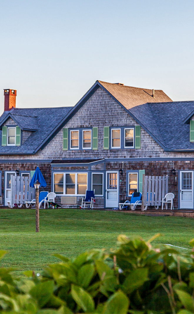 a house with lawn and chairs