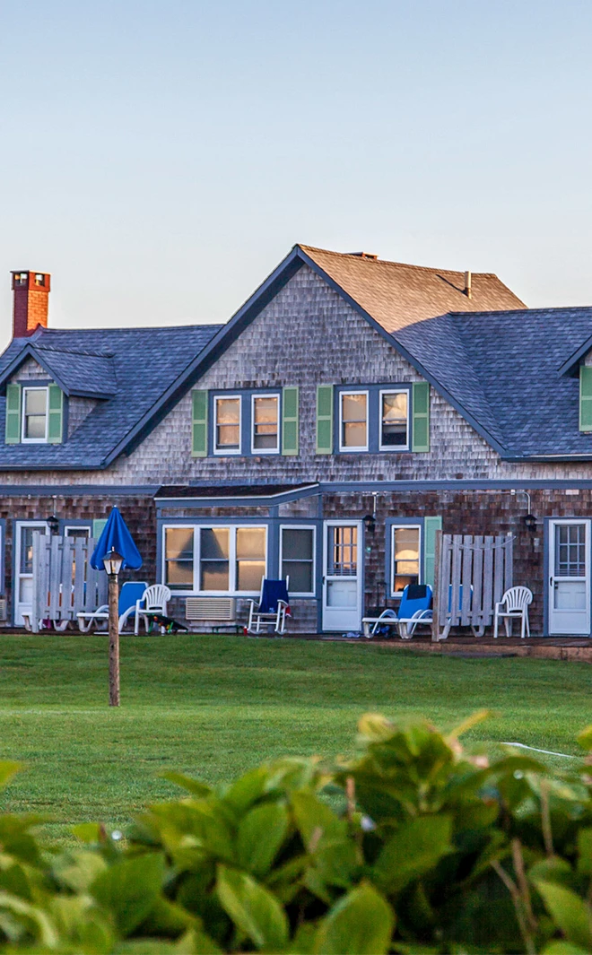 a house with lawn and chairs