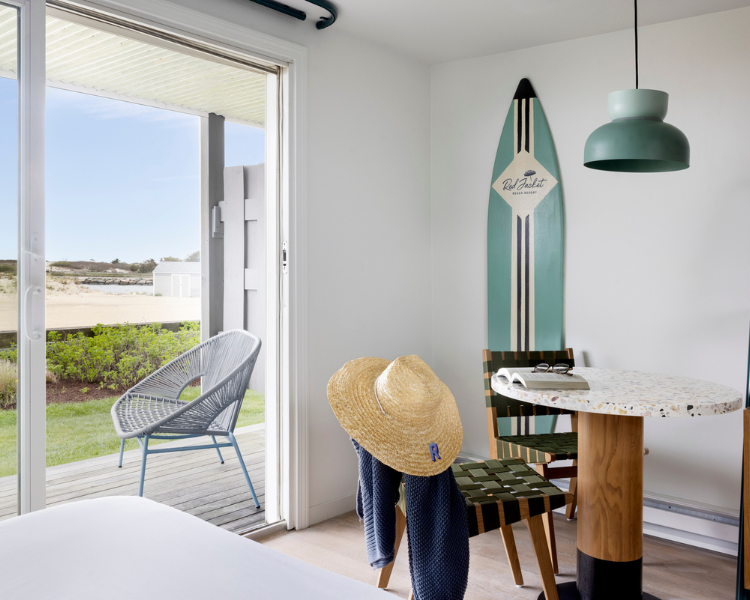 a room with a surfboard and a table