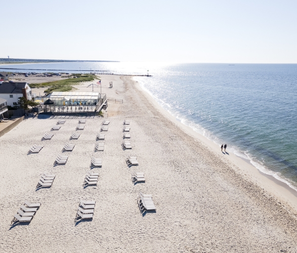 a beach with chairs and a body of water