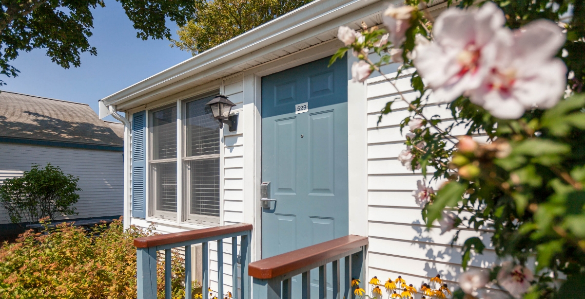 a house with a blue door and a railing