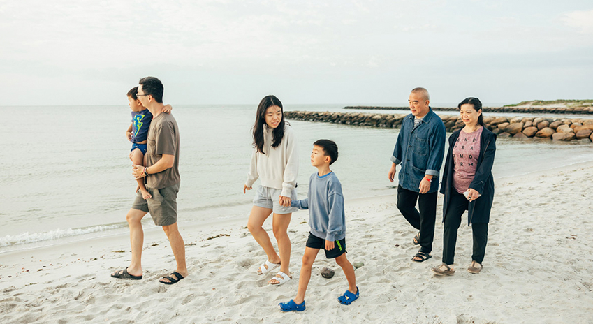 a group of people walking on a beach