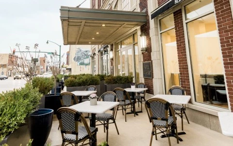 a patio with tables and chairs