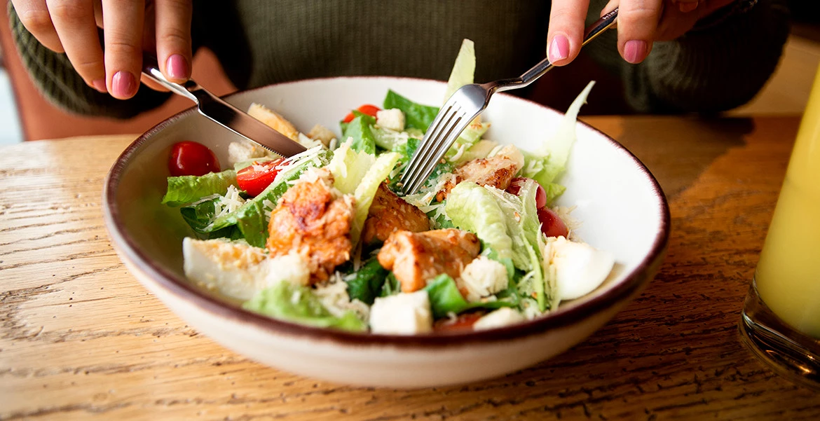 View of a person eating a salad