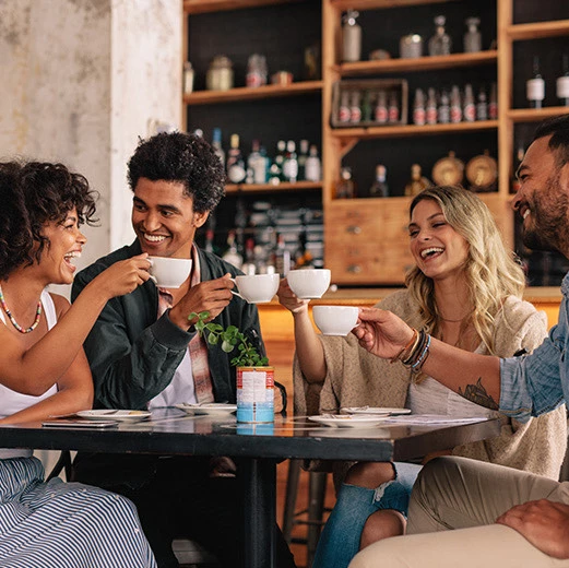 A group of happy friends gathering at the Relish Cafe