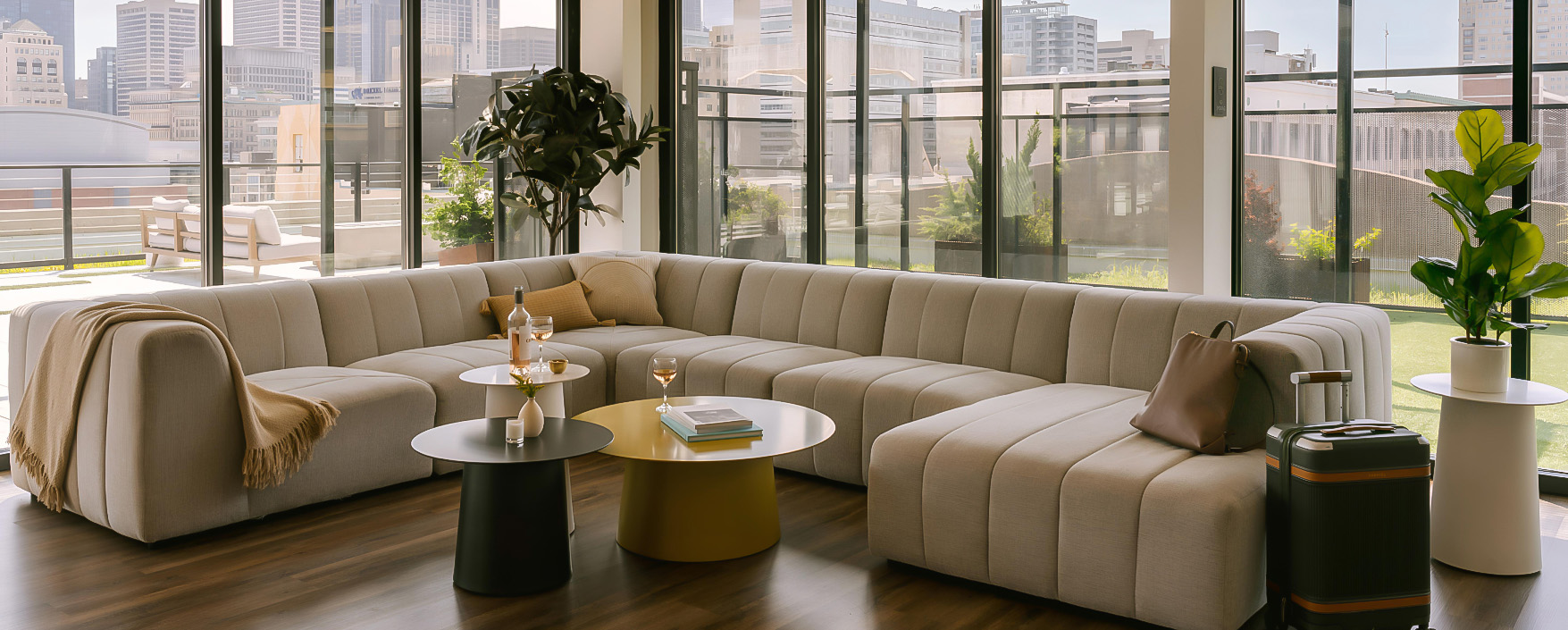a large couch in a room with a glass wall and a tree