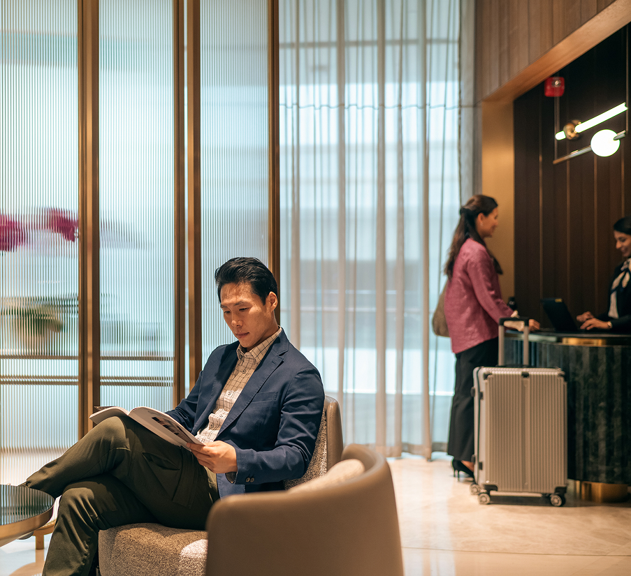 a man sitting in a chair reading a book