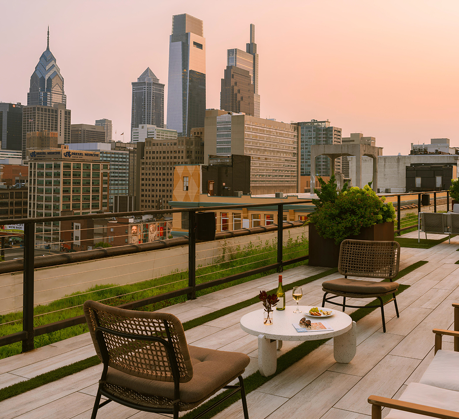 a rooftop patio with a city skyline in the background