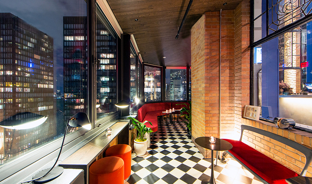 a room with a red couch and black and white checkered floor