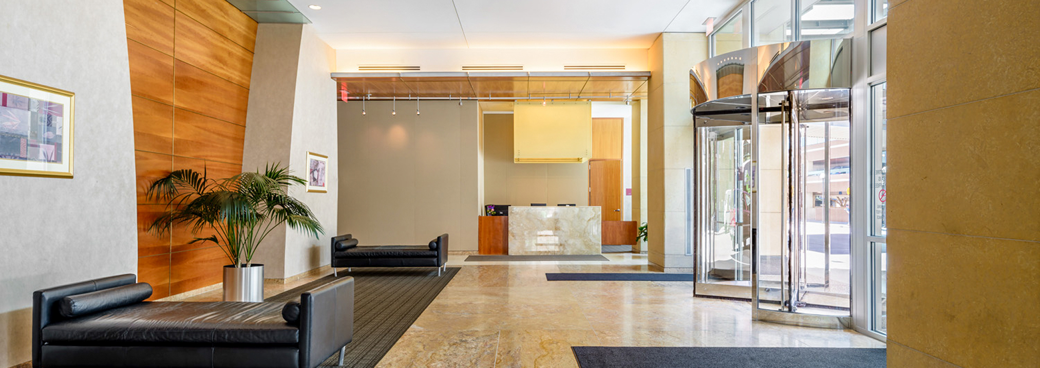 a lobby with a reception desk and chairs