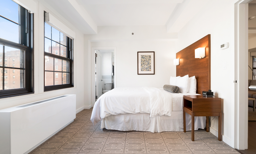 a bedroom with a bed and a table