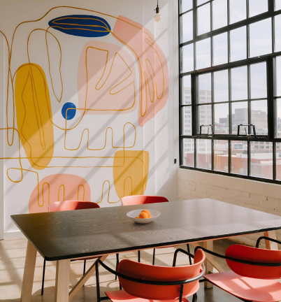 a table and chairs in a room with a large window