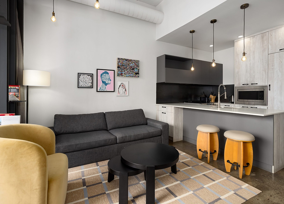 a living room with a couch and kitchen
