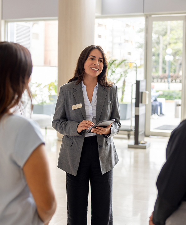 a woman in a suit holding a tablet