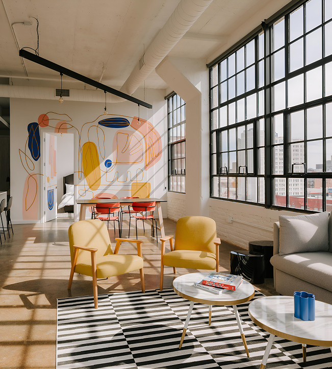 a room with a couch and chairs