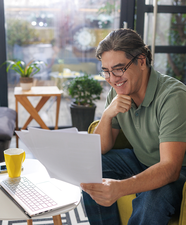a man sitting at a table with papers