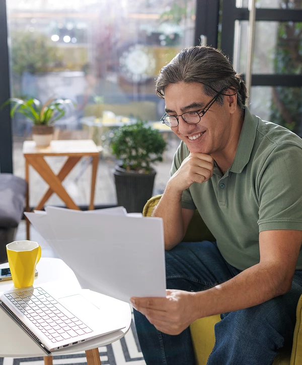 a man sitting at a table with papers