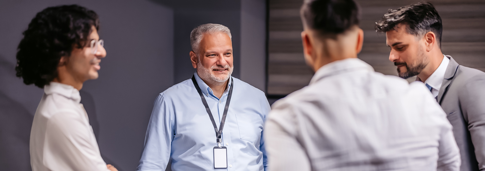 a man in a blue shirt talking to another man