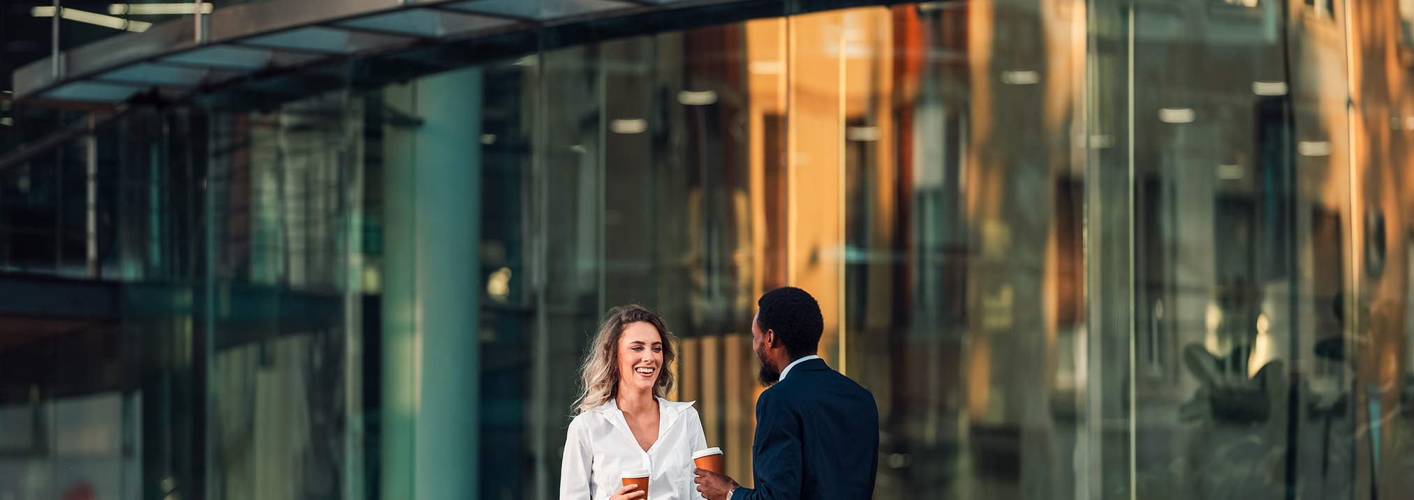 a man and woman holding coffee cups