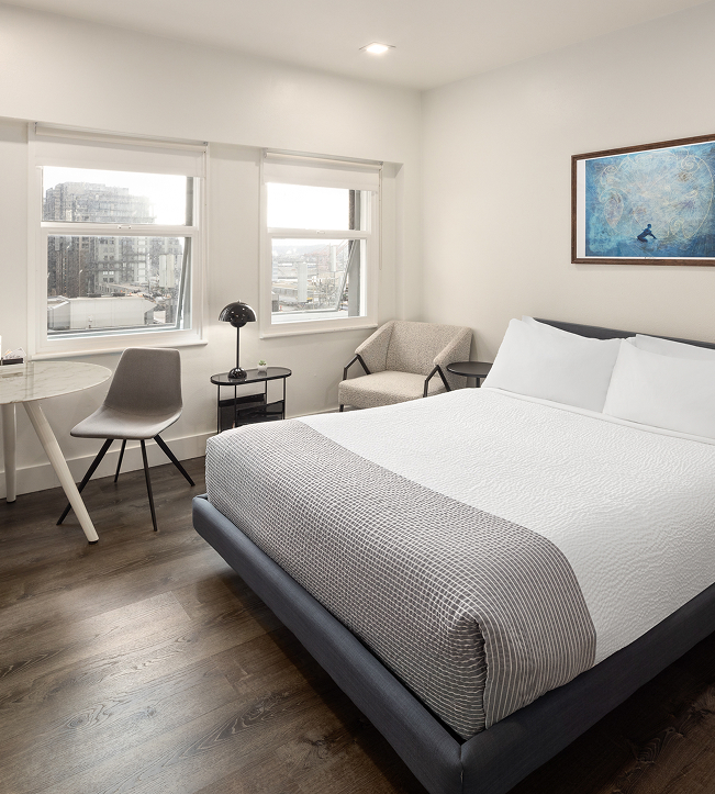 a bedroom with a bed and a table and chairs