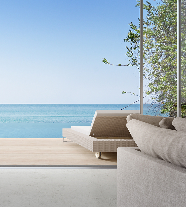 a couch on a deck overlooking a body of water