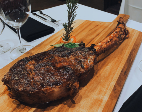 a cooked meat on a wooden board