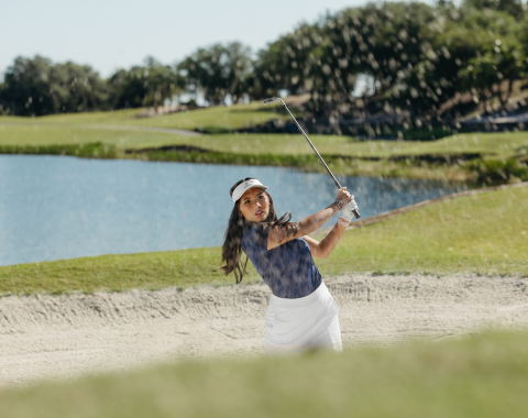 a woman swinging a golf club