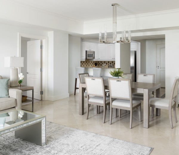 a dining room with a white table and chairs
