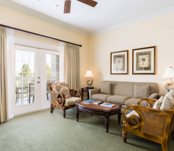 beige couch and large bright balcony window