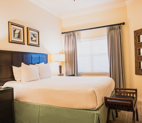 a bedroom with a bed and lamps