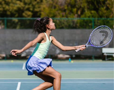 a girl playing tennis on a court