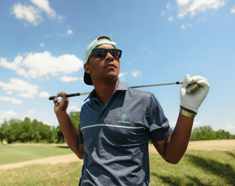 a man holding a golf club