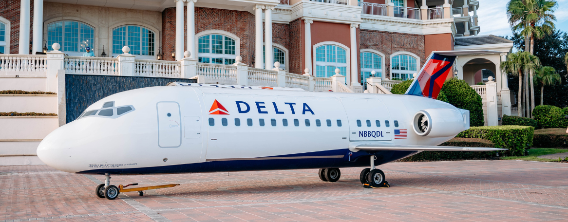 a white airplane parked in front of a building
