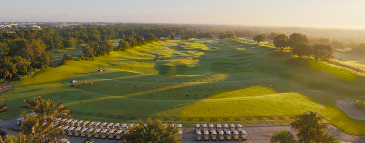 a golf course with cars parked on it