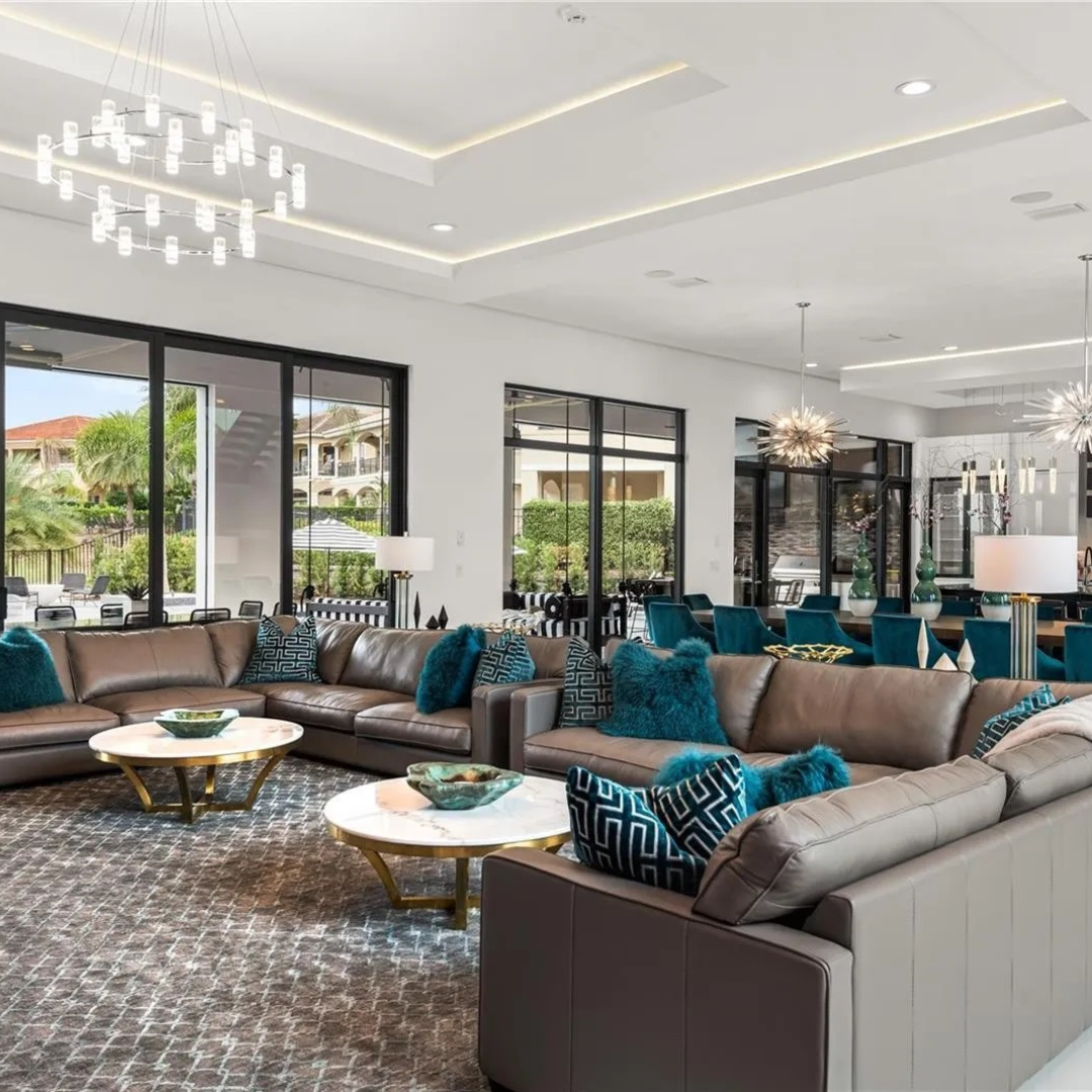 A spacious lobby with modern furniture and large windows.