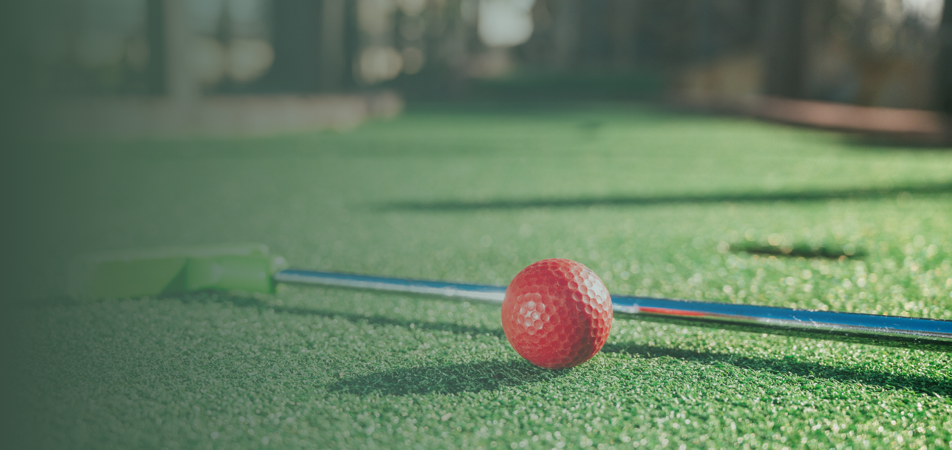 a golf ball on a green surface