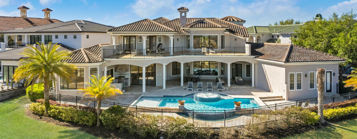 a large house with a pool and a fence